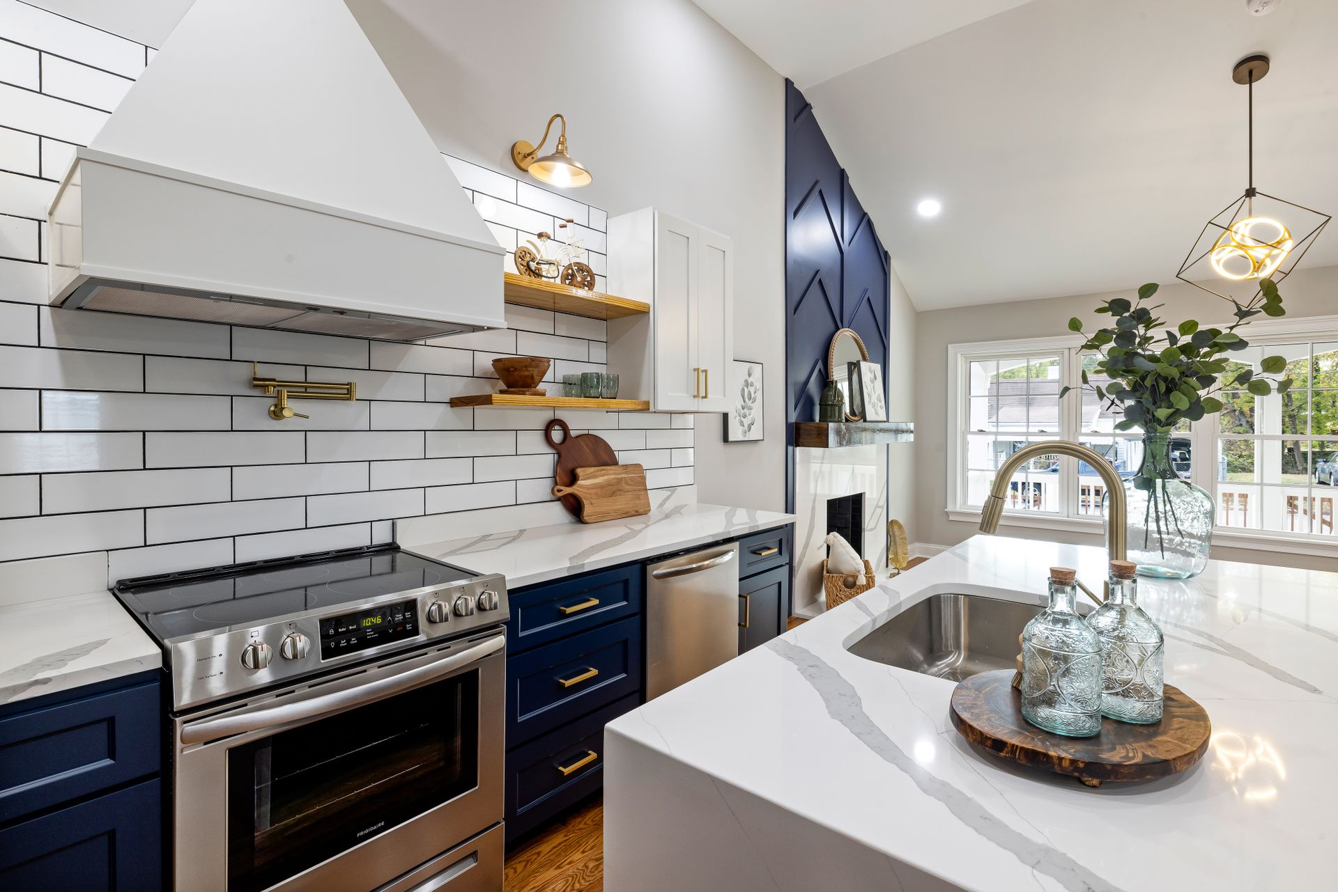 Luxury kitchen renovation with navy cabinetry and brass fixtures