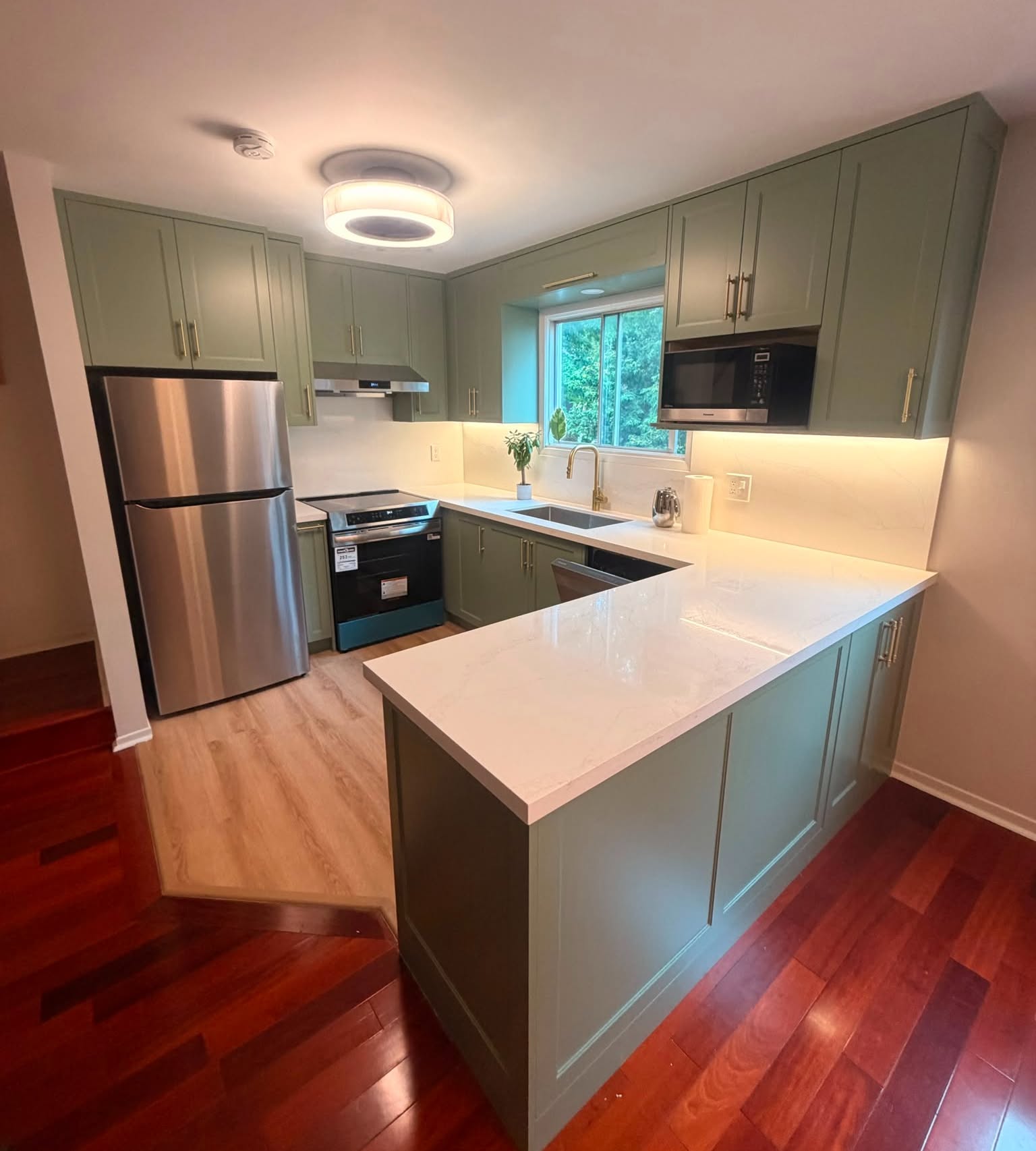 North York kitchen renovation with sage green cabinets and gold hardware